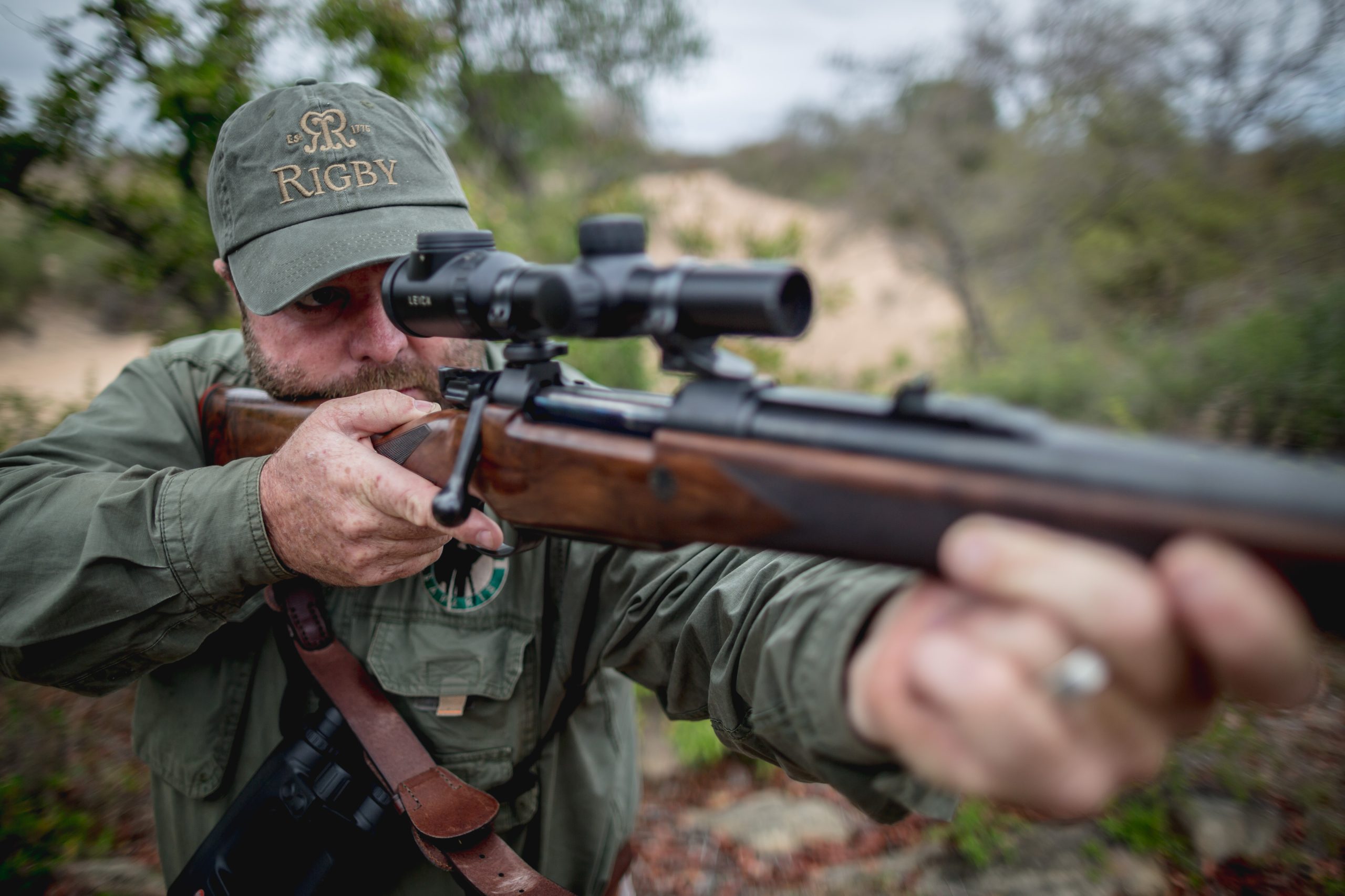 Man looking through scope on a rifle