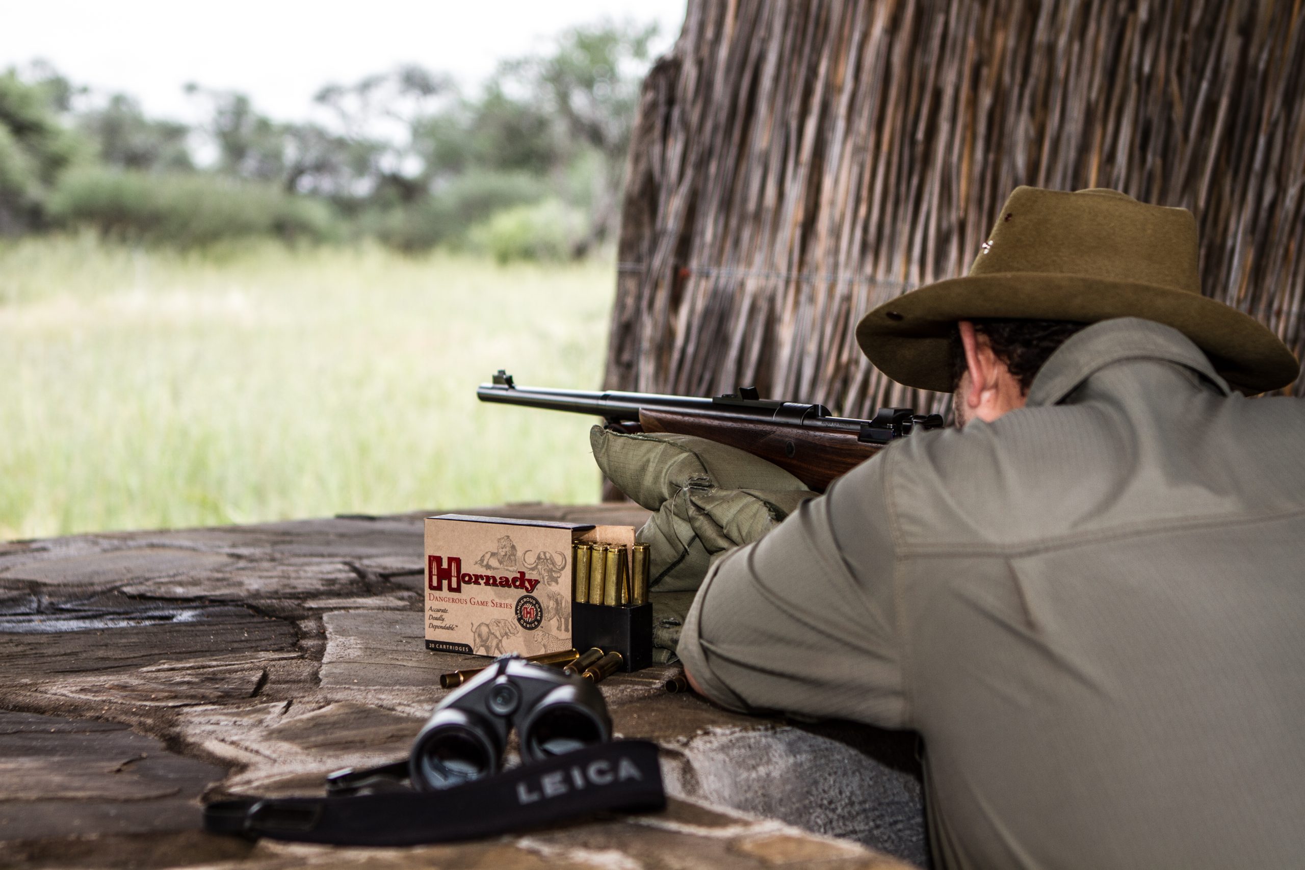 Man shooting his rifle off a bench