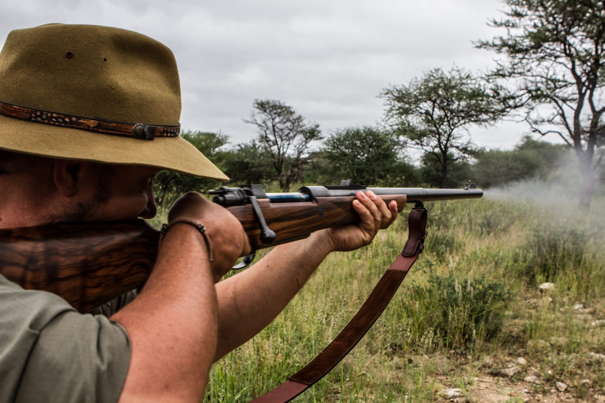 Man firing a rifle