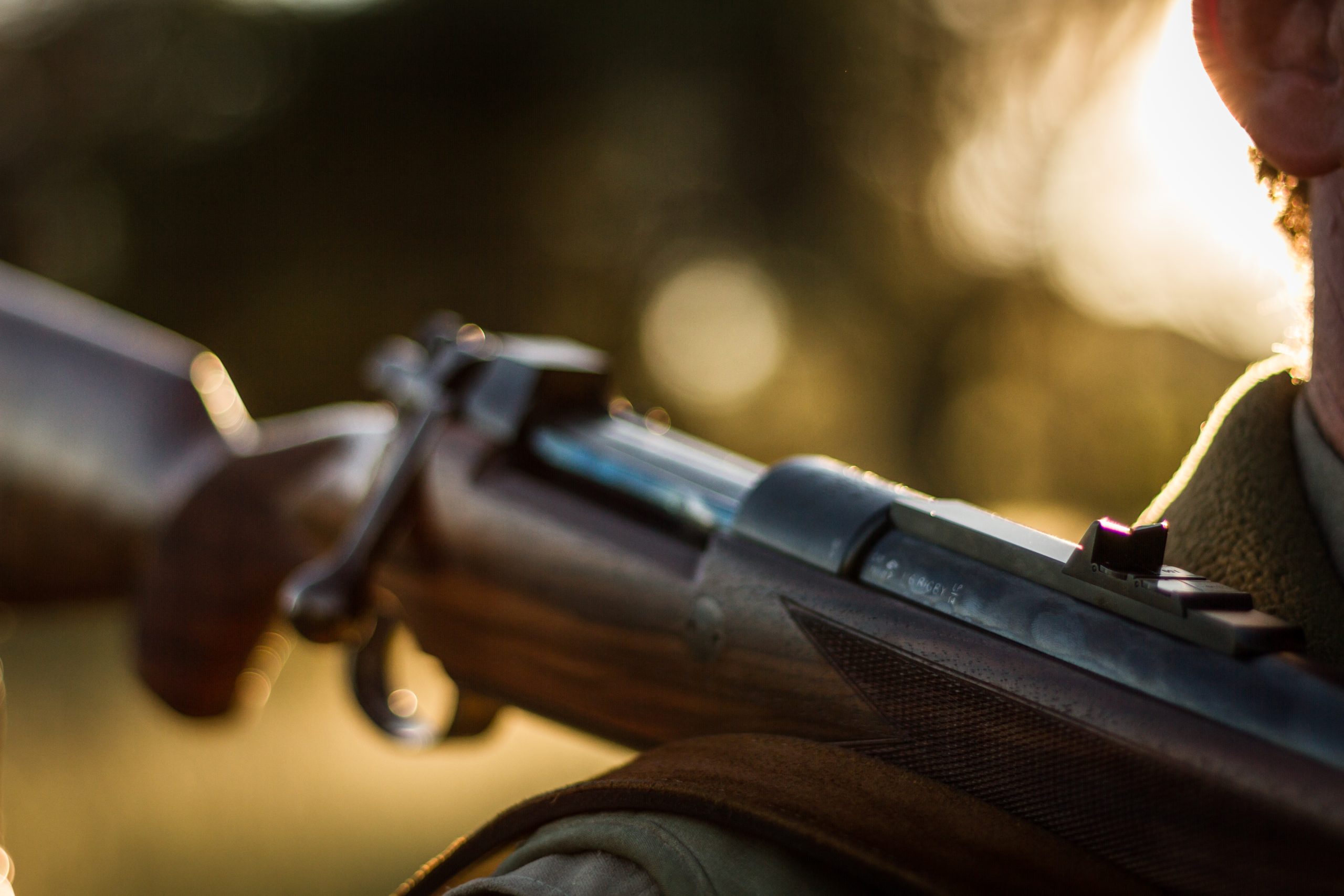 Rifle over mans shoulder